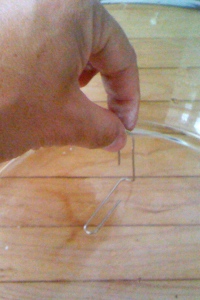 Image of paperclip being set towards the edge of the bowl