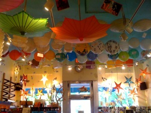 image of paper umbrellas and lanterns hanging from the ceiling